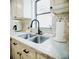Modern kitchen featuring granite countertops, a stainless steel sink, and elegant fixtures at 2300 Stratford Dr, Sarasota, FL 34232