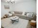 Spacious living room featuring a large sectional sofa, modern lighting, and comfortable decor at 2300 Stratford Dr, Sarasota, FL 34232