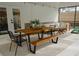 Relaxing covered patio featuring dining area and lounge seating with white decor at 2300 Stratford Dr, Sarasota, FL 34232