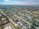 An aerial view showcasing a vast neighborhood with tree-lined streets and charming homes, surrounded by lush greenery and tranquil lakes at 2402 16Th W St, Palmetto, FL 34221