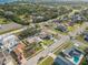 A charming neighborhood is captured from above, showcasing lovely homes, tree-lined streets, and inviting yards with some pools at 2402 16Th W St, Palmetto, FL 34221