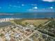 An aerial view showcases a home with a large body of water and a bright blue sky in the background at 2402 16Th W St, Palmetto, FL 34221