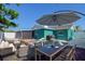 Cozy backyard featuring a dining table, fire pit, and lounge area, perfect for outdoor entertaining at 2402 16Th W St, Palmetto, FL 34221