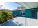 Simple patio area with lush plants against the fence, creating a tranquil outdoor space at 2402 16Th W St, Palmetto, FL 34221