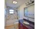This bathroom features a tub and shower combination with stunning tile and a sophisticated vanity with storage at 2402 16Th W St, Palmetto, FL 34221