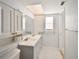 Bright bathroom with updated double sink vanity providing extra storage, tiled floors, and shower at 2402 16Th W St, Palmetto, FL 34221