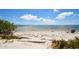 Beautiful view of the beach with a person relaxing in a chair and calm gulf water and blue sky at 2402 16Th W St, Palmetto, FL 34221
