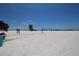 A beach view with volleyball nets, a lifeguard tower, and many people enjoying the sunshine at 2402 16Th W St, Palmetto, FL 34221