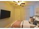Comfortable bedroom with ceiling fan, closet, television and neutral decor at 2402 16Th W St, Palmetto, FL 34221