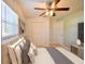 This staged bedroom features a ceiling fan, large window, and neutral colors to create a calming space at 2402 16Th W St, Palmetto, FL 34221