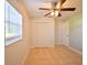 This bedroom features a ceiling fan, tile floor and large window, creating a bright and airy space at 2402 16Th W St, Palmetto, FL 34221