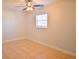 This bedroom features a ceiling fan, tile floor and large window, creating a bright and airy space at 2402 16Th W St, Palmetto, FL 34221