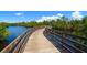 Curved wooden boardwalk winds over calm, reflective waters and green trees at 2402 16Th W St, Palmetto, FL 34221
