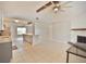Bright and airy living room with tile flooring, a ceiling fan, and an open layout to the kitchen at 2402 16Th W St, Palmetto, FL 34221