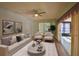 Bright living room featuring modern decor, light-colored furniture, and access to a sunroom at 2402 16Th W St, Palmetto, FL 34221