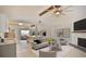 Bright living room featuring a fireplace, ceiling fan, and an open view to the kitchen and dining area at 2402 16Th W St, Palmetto, FL 34221