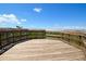 Spacious observation deck with wooden railing overlooking lush foliage and a beautiful Gulf view at 2402 16Th W St, Palmetto, FL 34221