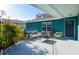 Relaxing outdoor patio features comfortable seating, lush plants, and views of the fenced backyard at 2402 16Th W St, Palmetto, FL 34221