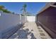 View of the side yard with well-maintained white fence and stone pavers leading to backyard at 2402 16Th W St, Palmetto, FL 34221