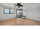 Bright bedroom featuring wood floors, and sliding glass doors to outdoor patio at 2415 Bayshore Gardens Pkwy # 8, Bradenton, FL 34207