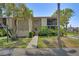 Condo with manicured lawn, tropical landscaping, and a sidewalk leading to the front at 2415 Bayshore Gardens Pkwy # 8, Bradenton, FL 34207