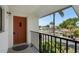 Balcony view of the front door and surrounding greenery at 2415 Bayshore Gardens Pkwy # 8, Bradenton, FL 34207