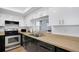 Kitchen featuring modern appliances and a pass-through window to the living space at 2415 Bayshore Gardens Pkwy # 8, Bradenton, FL 34207