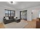 Cozy living room with neutral decor, sliding glass doors and wood-look flooring at 2415 Bayshore Gardens Pkwy # 8, Bradenton, FL 34207