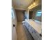 Bathroom with tiled shower, single sink vanity and medicine cabinet at 2808 60Th W Ave # 1924, Bradenton, FL 34207