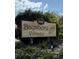 Community sign for Bayshore Village with mature landscaping and a conch shell decoration at 2808 60Th W Ave # 1924, Bradenton, FL 34207