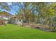 Large fenced backyard featuring green lawn, mature trees, and utility building at 3021 Leila Estelle Dr, Plant City, FL 33565