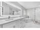 Modern bathroom with double vanity, large mirror, soaking tub, and frameless glass shower at 3021 Leila Estelle Dr, Plant City, FL 33565