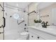 Bathroom with a white vanity, shower-tub combo with unique tile accent and a framed glass door at 3021 Leila Estelle Dr, Plant City, FL 33565
