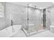Modern bathroom featuring a frameless glass shower, soaking tub, and white marble tile flooring at 3021 Leila Estelle Dr, Plant City, FL 33565