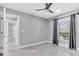 Bright bedroom featuring tile floors, a ceiling fan, and a window with views to the yard at 3021 Leila Estelle Dr, Plant City, FL 33565
