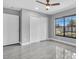Neutral bedroom features a ceiling fan, modern flooring, and a window view of the backyard at 3021 Leila Estelle Dr, Plant City, FL 33565