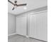 Bedroom with tile floors, ceiling fan, and multiple double-door closets for ample storage at 3021 Leila Estelle Dr, Plant City, FL 33565