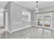 Elegant dining room with modern lighting and views of the pool through French doors at 3021 Leila Estelle Dr, Plant City, FL 33565