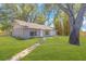 Charming single-story home with a well-manicured lawn and mature trees in a serene setting at 3021 Leila Estelle Dr, Plant City, FL 33565