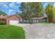 Home exterior with brick and siding, detached garage, and long driveway at 3021 Leila Estelle Dr, Plant City, FL 33565