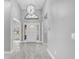 Bright and airy foyer featuring a grand chandelier and stylish tile flooring at 3021 Leila Estelle Dr, Plant City, FL 33565