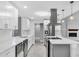 Updated kitchen with white cabinets, stainless steel appliances, island, and stone counters at 3021 Leila Estelle Dr, Plant City, FL 33565