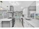 Modern kitchen boasts white cabinets, stainless steel appliances, and an island at 3021 Leila Estelle Dr, Plant City, FL 33565