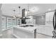 Open kitchen featuring white cabinetry, stainless appliances, a large island and pool view at 3021 Leila Estelle Dr, Plant City, FL 33565
