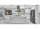 Stylish kitchen featuring white cabinets, stainless appliances, island, and pendant lighting at 3021 Leila Estelle Dr, Plant City, FL 33565