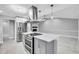 Modern kitchen island, stainless appliances, brick fireplace, and open-concept design at 3021 Leila Estelle Dr, Plant City, FL 33565