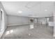 Large living room area with light gray paint, tile floors, and natural light at 3021 Leila Estelle Dr, Plant City, FL 33565