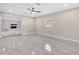 Spacious living room with marble tile floors and a fireplace in an open concept design at 3021 Leila Estelle Dr, Plant City, FL 33565