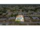 Aerial image outlines a property nestled in a residential area, near trees, showcasing the home's setting at 3095 Pinetree St, Port Charlotte, FL 33952