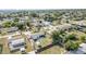 Aerial shot of property featuring the home, yard, and surrounding neighborhood with lush vegetation and street views at 3095 Pinetree St, Port Charlotte, FL 33952
